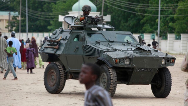 FILE - Nigerian soldiers ride on an armored personnel carrier during Eid al-Fitr celebrations in Maiduguri, in Borno state, Nigeria. Thursday, Aug. 8, 2013. (AP Photo/Sunday Alamba, File)
