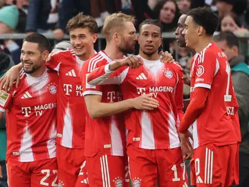 Germany Bundesliga Soccer Bayern's Michael Olise, third from right, celebrates with teammates after scoring his side's third goal during the German Bundesliga soccer match between FC St. Pauli and Bayern Munich in Hamburg, Germany, Saturday, April 11, 2026. (Christian Charisius/dpa via AP)