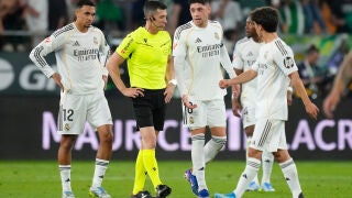 Real Madrid players talk to the referee during a La Liga soccer match between Real Betis and Real Madrid in Seville, Spain, Friday, April 24, 2026. (AP Photo/Jose Breton)