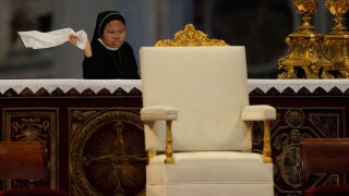 A nun dusts the altar prior to the start of Pope Leo XIV's Pentecost Mass in St. Peter's Basilica, at the Vatican, Sunday, May 24, 2026. (AP Photo/Gregorio Borgia)