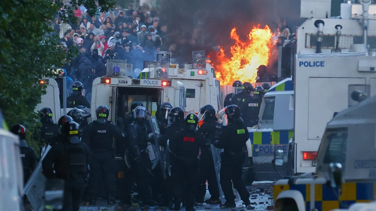 Police attempt to clear protesters near Newtownabbey, in Belfast, Northern Ireland, Wednesday, June 10, 2026, following a stabbing incident on Monday night.