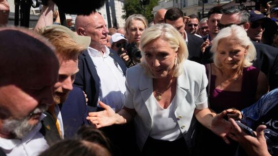 Far-right leader Marine Le Pen arrives to visit a market in La Fleche, western France Wednesday, July. 8, 2026. (AP Photo/Michel Euler)