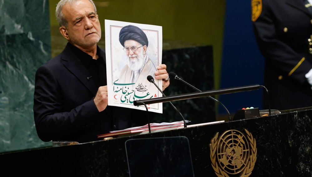 Iran's President Masoud Pezeshkian holds an image of late Iranian Supreme Leader Ayatollah Ali Khamenei during the 81st session of the United Nations General Assembly at United Nations headquarters, Wednesday, Sept. 23, 2026. (AP Photo/Stefan Jeremiah)