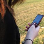 Una mujer utiliza un teléfono móvil para hacer una llamada