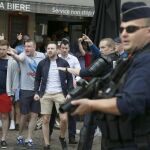 Hinchas ingleses y de gales, custodiados por la policía en Lille.