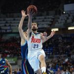 El base del Real Madrid Sergio Llull (d) entra a canasta ante el jugador del Morabanc Andorra Giorgi Shermadini