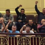 Un grupo de estibadores saluda desde la tribuna de invitados del Congreso