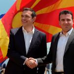El primer ministro griego Alexis Tsipras (i) y el primer ministro de la ex República Yugoslava de Macedonia, Zoran Zaev (d) se dan la mano a su llegada hoy al lado macedonio del lago Prespa, cerca de Otesevo / EFE BATEV