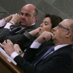 Soraya Sáenz de Santamaría, acompañada por Luis de Guindos y Cristóbal Montoro, durante la rueda de prensa posterior al Consejo de Ministros que hoy ha aprobado la Actualización del Programa de Estabilidad 2016-2019 y el Plan Nacional de Reformas 2016.