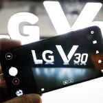 Un visitante observa el nuevo modelo de teléfono móvil V30, durante la IFA
