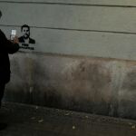 Un hombre fotografía una pintada de Junqueras