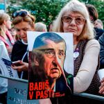 Una mujer sostiene una pancarta en la que puede leerse ''Babis atrapado'', mientras miles de manifestantes protestan en la plaza Wenceslas contra el primer ministro checo, Andrej Babis