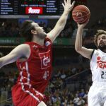 El base del Real Madrid Sergio Llull tira ante el escolta del CAI Chris Goulding.