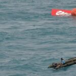 Parte de la cola del avión de AirAsia flotando en el mar.