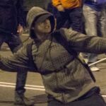 Un joven tira una piedra, al término de las marchas por la dignidad