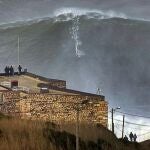 El surfista hawaiano Garrett McNamara (c) coge una ola gigante en la playa de Nazare, Portugal hoy, martes 29 de enero de 2013. Según informes locales, tras haber surfeado esta ola, McNamara ha batido su propio récord mundial. EFE/To Mane