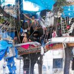 En la foto de la izquierda, un grupo de indignados permanece en su «campamento» en el que incluso se han construido cabañas en los árboles. Abajo, miembros de la limpieza iniciaron ayer sus labores de desalojo.