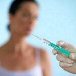 Un profesional se dispone a suministrar botox a una paciente
