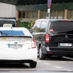 Un taxi y un vehículo VTC en el aeropuerto de Madrid