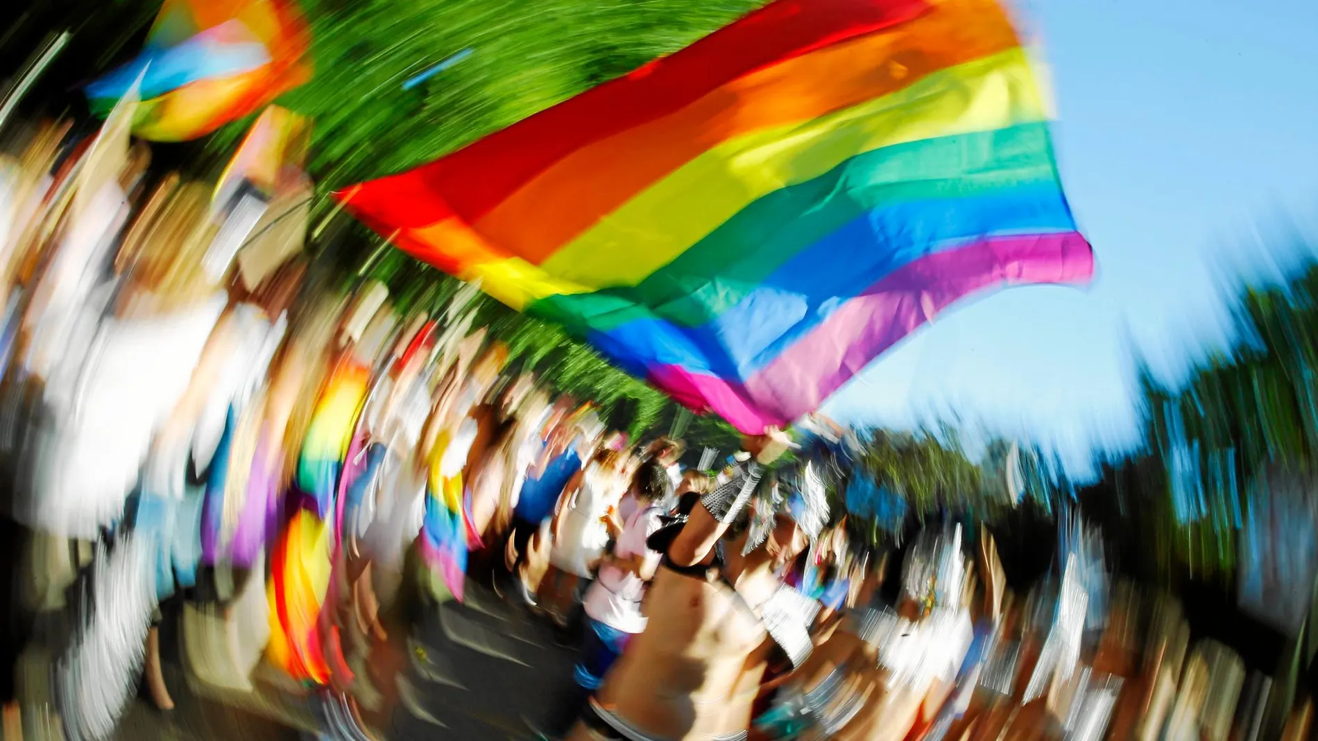 Un joven ondea la bandera del Orgullo en Madrid