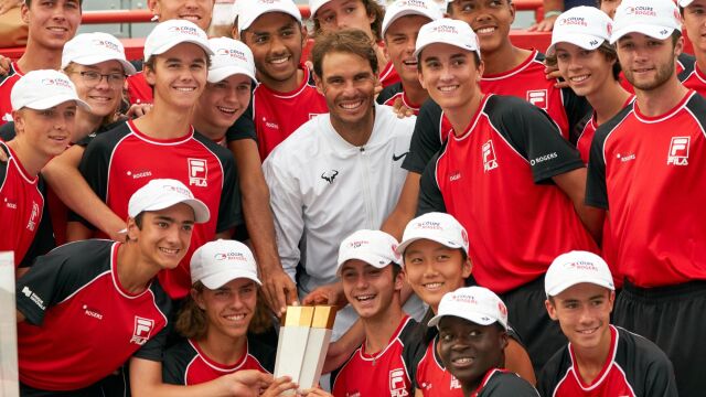 Rafa Nadal posa con los recogepelotas y con el trofeo logrado en Montreal