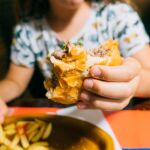 Evitar comer alimentos que requieran las manos, como los bocadillos, o acompañar las comidas con alimentos integrales y crudos promueve una ingesta más pausada 