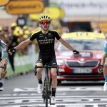 [and Austria's Gregor Muhlberger, celebrates as he crosses the finish line to win the twelfth stage of the Tour]