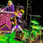 MIke Scott, con sombrero, saltando, en una actuación reciente al frente de The Waterboys