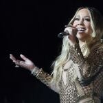 FILE - This Oct. 20, 2019 file photo shows Mariah Carey performing during a concert celebrating Dubai Expo 2020 One Year to Go in Dubai, United Arab Emirates. A memoir by Mariah Carey is on the list of titles from Andy Cohen Books. Henry Holt and Company announced Thursday that Cohenâ€™s self-named imprint will launch in 2020. It says the imprint will feature three nonfiction works by women. Careyâ€™s memoir will be about her journey to superstar status. (AP Photo/Kamran Jebreili, File)