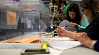 Varios ciudadanos en una mesa electoral Una mesa electoral