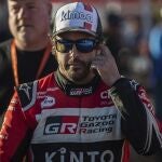 Driver Fernando Alonso, of Spain, walks at the bivouac after stage two of the Dakar Rally in Neom, Saudi Arabia, Monday, Jan. 6, 2020. (AP Photo/Bernat Armangue)