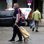 GRAF8001. MADRID, 17/03/2020.- Un hombre camina con el carro de la compra este martes por una calle madrile&ntilde;a. Las personas mayores que viven solas se han convertido en uno de los colectivos m&aacute;s vulnerables de la crisis del coronavirus ya que adem&aacute;s del riesgo que les supone contraer la enfermedad, deben permanecer aislados y sin recibir m&aacute;s visitas que las imprescindibles, lo que contribuye a su aislamiento y soledad. EFE/Kiko Huesca
