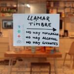 Un cartel en el exterior de una farmacia en el centro de Valencia advierte de que tanto guantes, mascarillas y alcohol se encuentran agotados durante el cuarto día del estado de alarma decretado por el Gobierno.EFE/ Biel Aliño