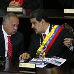 FILE - In this Jan. 24, 2019 file photo, Venezuelan President Nicolas Maduro, right, speaks with Constitutional Assembly President Diosdado Cabello at the Supreme Court during an annual ceremony that marks the start of the judicial year in Caracas, Venezuela. On Thursday, March 26, 2020, the U.S. Justice Department made public it has charged in several indictments against Maduro and his inner circle, including Cabello, that the leader has effectively converted Venezuela into a criminal enterprise at the service of drug traffickers and terrorist groups as he and his allies stole billions from the South American country. (AP Photo/Ariana Cubillos, File)