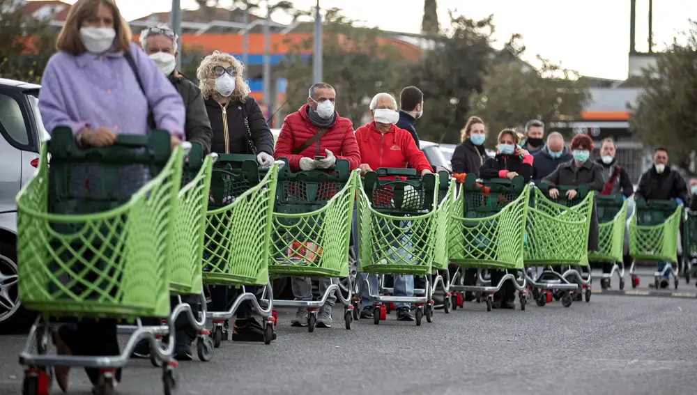 -FOTODELDÍA- EPA1736 ROMA (ITALIA), 27/03/2020.- Ciudadanos ataviados con guantes y mascarillas hacen cola para comprar en un supermercado este viernes, en Roma, Italia. El número de fallecidos en Italia con el coronavirus alcanzó hoy los 9.134, al registrarse 969 en las últimas veinticuatro horas, un aumento récord en el cómputo de víctimas de esta pandemia. EFE/Massimo Percossi