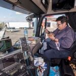Un camionero come en la cabina de su camión durante un descanso de su ruta
