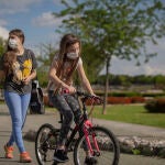 Una mujer con su hija pasean por el parque en el tercer día de desconfinamiento de niños y preadolescentes durante el estado de alarma