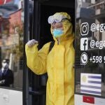A crew member from the Australian cruise ship Greg Mortimer gets dropped off at a hotel in Montevideo, Uruguay, Tuesday, May 12, 2020. Their ship has been anchored off the coast since March 27 and today the crew, some infected with the new coronavirus, will quarantine at two hotels. (AP Photo/Matilde Campodonico)