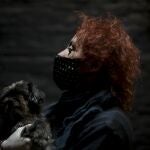 Actor Fabio "Mosquito" Sancineto poses with her dog for a portrait inside a closed theater in Buenos Aires, Argentina, Saturday, May 16, 2020. Sancineto is the promoter of Solidarity Artists, an initiative to help fellow artists struggling to eat and pay bills after months without work after hundreds of theaters were closed by the mandatory lockdown to stop the spread of the new coronavirus. (AP Photo/Natacha Pisarenko)