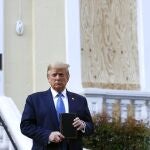 President Donald Trump holds a Bible as he visits outside St. John's Church across Lafayette Park from the White House Monday, June 1, 2020, in Washington. Part of the church was set on fire during protests on Sunday night. (AP Photo/Patrick Semansky)