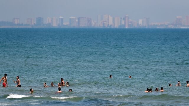Un gran número de personas se refresca en las aguas de la playa de la Malvarrosa