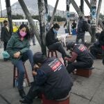 Wearing a mask to curb the spread of the new coronavirus, Daisy Avila Paredes, left, has her boots shined in Lima, Peru, Wednesday, July 1, 2020. (AP Photo/Rodrigo Abd)