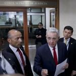 FILE - In this Oct. 8, 2019 file photo, senator and former president Alvaro Uribe arrives to the Supreme Court for questioning in an investigation for witness tampering charges in Bogota, Colombia. Uribe will not be allowed to remain at liberty while the Supreme Court investigates the allegations against him, current President Ivan Duque said in a video address Tuesday, Aug. 4, 2020. (AP Photo/Ivan Valencia, File)