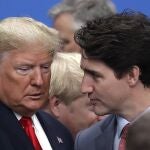 FILE - In this Wednesday, Dec. 4, 2019, file photo, U.S. President Donald Trump, left, and Canadian Prime Minister Justin Trudeau arrive for a round table meeting during a NATO leaders meeting at The Grove hotel and resort in Watford, Hertfordshire, England. Less than a month after Trumpâ€™s U.S.-Mexico-Canada Agreement took effect July 1, 2020, the Trump administration is scheduled to re-impose a 10% import tax on Canadian aluminum Sunday, Aug. 16, raising tensions between the two allies. (AP Photo/Evan Vucci, File)