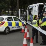 Police officers secure the area after a man was found fatally stabbed late Saturday, in Birmingham, England, Sunday Aug. 23, 2020. A 15-year-old girl and a 28-year-old woman were detained at the scene and according to the police, they remain in custody. (Jacob King/PA via AP)