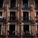 Vecinos de un edificio de Madrid en sus balcones durante el confinamiento por la epidemia de coronavirus
