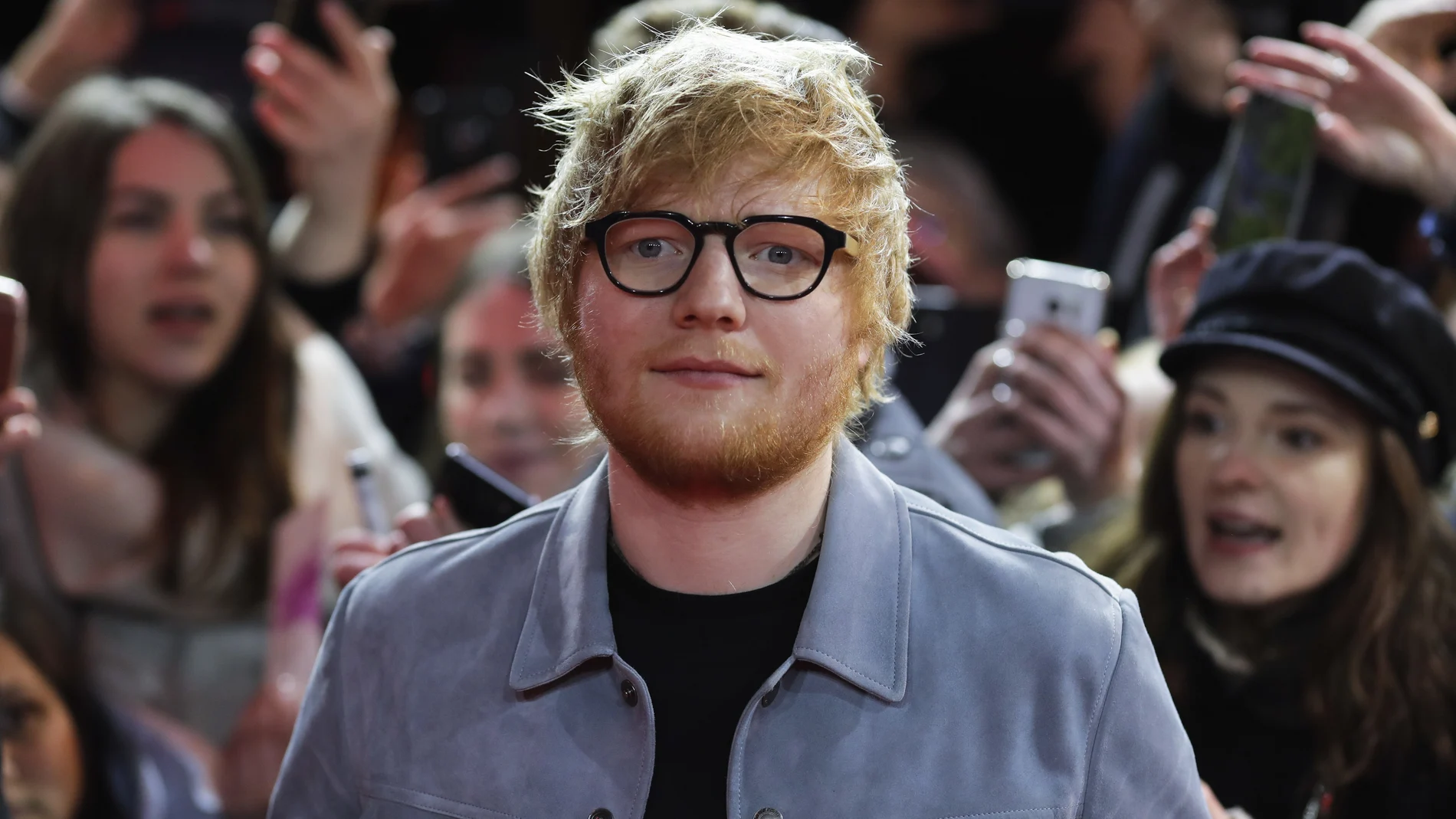 FILE - In this Friday, Feb. 23, 2018 file photo, singer-songwriter Ed Sheeran, center, arrives for the screening of the film 'Songwriter' during the 68th edition of the International Film Festival Berlin, Berlinale, in Berlin, Germany. Ed Sheeran and his wife Cherry have announced the birth of their daughter Lyra Antarctica Seaborn Sheeran. The singer-songwriter said in an Instagram post that the couple’s “beautiful and healthy daughter†was born last week. (AP Photo/Markus Schreiber, File)