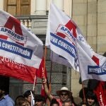 FILE - In this Feb. 26, 2020 file photo, people wave flags in favor of the rewriting of the Chilean Constitution at a campaign event in Santiago, Chile, Wednesday. Chileâ€™s government has initiated on Wednesday, Oct. 7, 2020, a campaign to incentivize participation in a plebiscite that will take place on Oct. 25, to see if the people will vote to replace the constitution that was written during the 1973-1990 military dictatorship of Gen. Augusto Pinochet. (AP Photo/Esteban Felix, File)