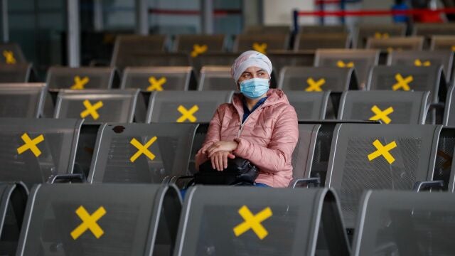 Un pasajero espera en la zona de espera de un aeropuerto
