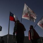 Supporters walk with flags in favor of the rewriting of the Chilean Constitution, to replace one dating back to the Pinochet dictatorship, at a campaign event in Santiago, Chile, Thursday, Oct. 22, 2020. Politicians agreed late last year that Congress should lead the process of writing a new constitution, one of a series of measures aimed at quelling protests over economic inequality and other grievances. (AP Photo/Esteban Felix)